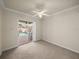 Bedroom featuring carpet and a sliding glass door to the pool at 13216 Legends Trl, Dade City, FL 33525
