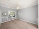 Bedroom featuring neutral walls, carpeted floors, and a bright window at 13216 Legends Trl, Dade City, FL 33525