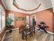 Elegant dining room featuring an orange accent wall and a modern light fixture at 13216 Legends Trl, Dade City, FL 33525