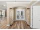 Elegant foyer featuring marble columns, wood floors, and bright double doors at 13216 Legends Trl, Dade City, FL 33525