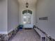 Inviting front entrance with double doors, stone accents, and a welcoming bench at 13216 Legends Trl, Dade City, FL 33525