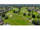 Scenic golf course with manicured greens and surrounding residential community on a sunny day at 13216 Legends Trl, Dade City, FL 33525