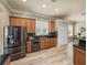 Gourmet kitchen with granite countertops, wood cabinetry, stainless appliances and wood flooring at 13216 Legends Trl, Dade City, FL 33525