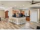 Open concept kitchen with wood cabinets, granite counters, breakfast bar, and stainless steel appliances at 13216 Legends Trl, Dade City, FL 33525