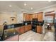 Gourmet kitchen with granite countertops, wood cabinetry, breakfast bar and wood flooring at 13216 Legends Trl, Dade City, FL 33525