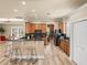 Open concept kitchen with wood cabinets, granite counters, breakfast bar, and stainless steel appliances at 13216 Legends Trl, Dade City, FL 33525
