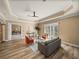 Open-concept living room with wood floors, high ceilings, and abundant natural light at 13216 Legends Trl, Dade City, FL 33525