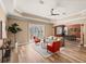 Bright living room with wood floors, decorative ceiling, and large windows at 13216 Legends Trl, Dade City, FL 33525