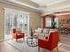 Cozy living room with bright furniture and a large window with wood shutters at 13216 Legends Trl, Dade City, FL 33525
