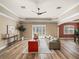 Spacious living room with wood floors, tray ceiling, and natural light at 13216 Legends Trl, Dade City, FL 33525