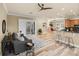 Comfortable living room with a ceiling fan, modern furnishings, and access to the patio at 13216 Legends Trl, Dade City, FL 33525