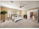Spacious main bedroom features a ceiling fan, neutral carpeting, and a charming fireplace at 13216 Legends Trl, Dade City, FL 33525