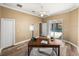 Spacious office with a view of the pool area and a light ceiling fan at 13216 Legends Trl, Dade City, FL 33525
