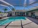 Lovely pool area with a large screened-in patio, ideal for relaxing or entertaining at 13216 Legends Trl, Dade City, FL 33525