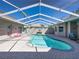 Inviting screened-in pool with a brick-paved patio perfect for relaxation and entertaining at 13216 Legends Trl, Dade City, FL 33525