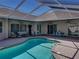 Inviting screened-in pool with patio furniture, perfect for Florida living at 13216 Legends Trl, Dade City, FL 33525