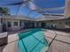 A gorgeous pool with a screened-in patio, furniture, and ample space for entertaining at 13216 Legends Trl, Dade City, FL 33525