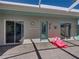 Screened pool area showing brick pavers and a pink flamingo floaty sitting on the patio at 13216 Legends Trl, Dade City, FL 33525