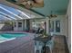 Outdoor living space with a pool, covered patio, ceiling fans, and outdoor dining area at 13216 Legends Trl, Dade City, FL 33525