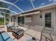 Cozy screened-in patio with comfortable seating and tiled floor, great for relaxation at 13216 Legends Trl, Dade City, FL 33525