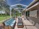 Inviting screened patio with comfortable furniture, offering a relaxing outdoor space at 13216 Legends Trl, Dade City, FL 33525