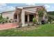 Covered patio, lush landscaping, and a grill area at 329 Grayston Pl # 112, Sun City Center, FL 33573