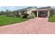 Single-story home with a carport and landscaped yard at 329 Grayston Pl # 112, Sun City Center, FL 33573