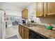 Functional kitchen with wood cabinets and stainless steel appliances at 329 Grayston Pl # 112, Sun City Center, FL 33573