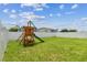 Grass backyard with playset at 17350 Garden Heath Ct, Land O Lakes, FL 34638