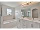 Main bathroom with double vanity, soaking tub and separate shower at 17350 Garden Heath Ct, Land O Lakes, FL 34638