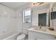Updated bathroom with white vanity, bathtub, and a large mirror at 17350 Garden Heath Ct, Land O Lakes, FL 34638