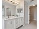 Main bathroom with double vanity and walk-in closet at 17350 Garden Heath Ct, Land O Lakes, FL 34638