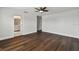 Spacious bedroom with dark brown wood flooring and ceiling fan at 17350 Garden Heath Ct, Land O Lakes, FL 34638