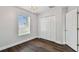 Bedroom with double door closet, window and hardwood floors at 17350 Garden Heath Ct, Land O Lakes, FL 34638