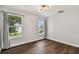 Bright bedroom with two windows, hardwood floors, and neutral walls at 17350 Garden Heath Ct, Land O Lakes, FL 34638