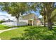 Two-story house with a white fence and a palm tree in the front yard at 17350 Garden Heath Ct, Land O Lakes, FL 34638
