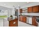 Modern kitchen with granite countertops, stainless steel appliances, and wood cabinets at 17350 Garden Heath Ct, Land O Lakes, FL 34638