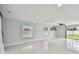 Bright and airy living room with tile flooring and large windows at 17350 Garden Heath Ct, Land O Lakes, FL 34638