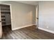 Spacious bedroom with an open closet door, neutral walls, and modern wood-look floors is move-in ready at 1920 N Highland Ave, Clearwater, FL 33755
