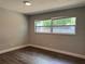 Bright bedroom featuring a large window offers a simple and elegant design with natural light at 1920 N Highland Ave, Clearwater, FL 33755