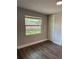 Bedroom featuring laminate floors, neutral walls, window and closet at 1920 N Highland Ave, Clearwater, FL 33755