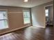 Bedroom with dark floors and two windows, adjacent to the bathroom, provides natural light and exterior views at 1920 N Highland Ave, Clearwater, FL 33755