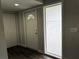 Bright entryway featuring a front door with decorative glass, wood-look flooring and a coat closet at 1920 N Highland Ave, Clearwater, FL 33755