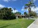 Charming home with a well-manicured lawn, mature trees, and a sunny curb appeal at 1920 N Highland Ave, Clearwater, FL 33755