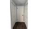 Hallway showcasing neutral paint, laminate floors and closets at 1920 N Highland Ave, Clearwater, FL 33755