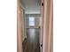 Hallway featuring neutral paint, laminate floors and a window providing natural light at 1920 N Highland Ave, Clearwater, FL 33755