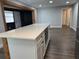 Open concept kitchen with white cabinets, quartz countertops, and wood accents at 1920 N Highland Ave, Clearwater, FL 33755