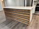 Kitchen island featuring a quartz countertop and wood-finished siding at 1920 N Highland Ave, Clearwater, FL 33755