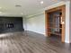 Bright living room featuring a wood-look floor, fireplace, and built-in shelving with natural light at 1920 N Highland Ave, Clearwater, FL 33755