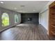 Open living room with a brick fireplace, hardwood floors and natural light streaming through large windows at 1920 N Highland Ave, Clearwater, FL 33755